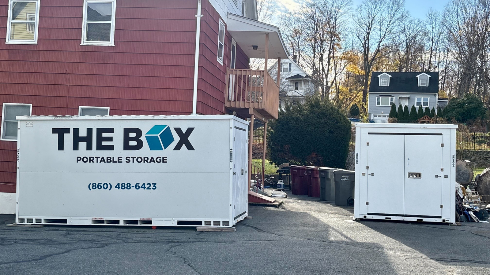 PODS containers in a field with red truck